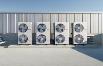 Industrial air conditioning units on a building rooftop.